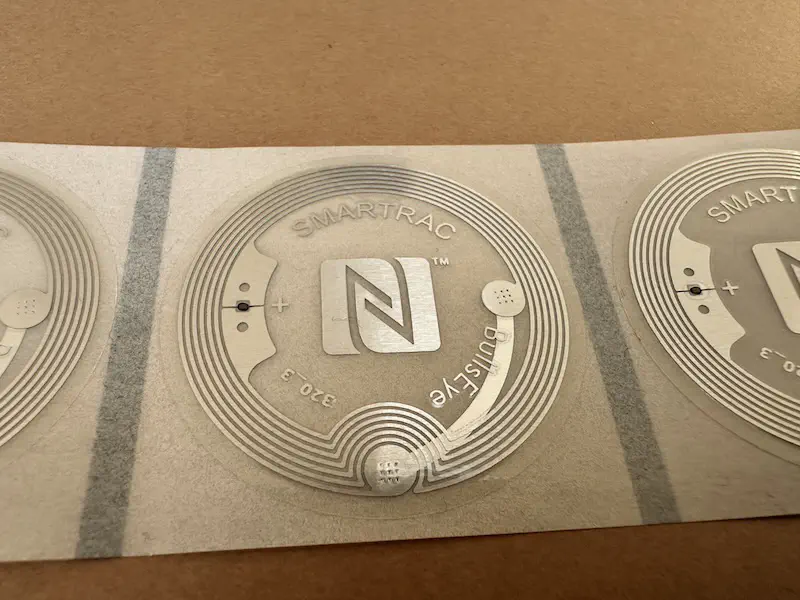 A photo showing the AD Bullseye NFC tag on an adhesive film strip